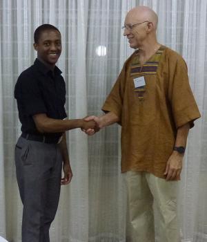 Chris Callaghan (right) -  Agora Ambassador and President of the Agora Speakers Queenswood Club in Pretoria, South Africa, greeting speaker Aaron Masemola (left).